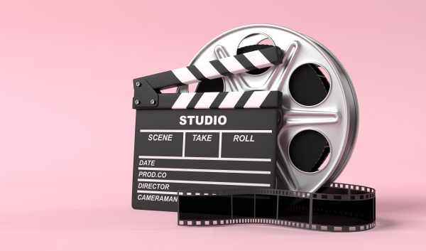 Film clapperboard and film reel on a pink background – Automation of invoice handling with Continia Document Capture at Miso Film
